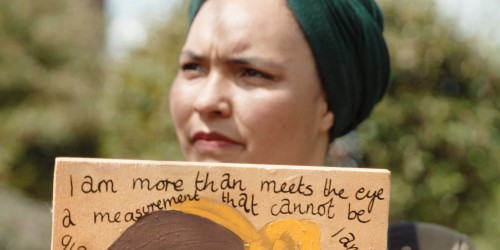 Artist holding up artwork for cabot conversations